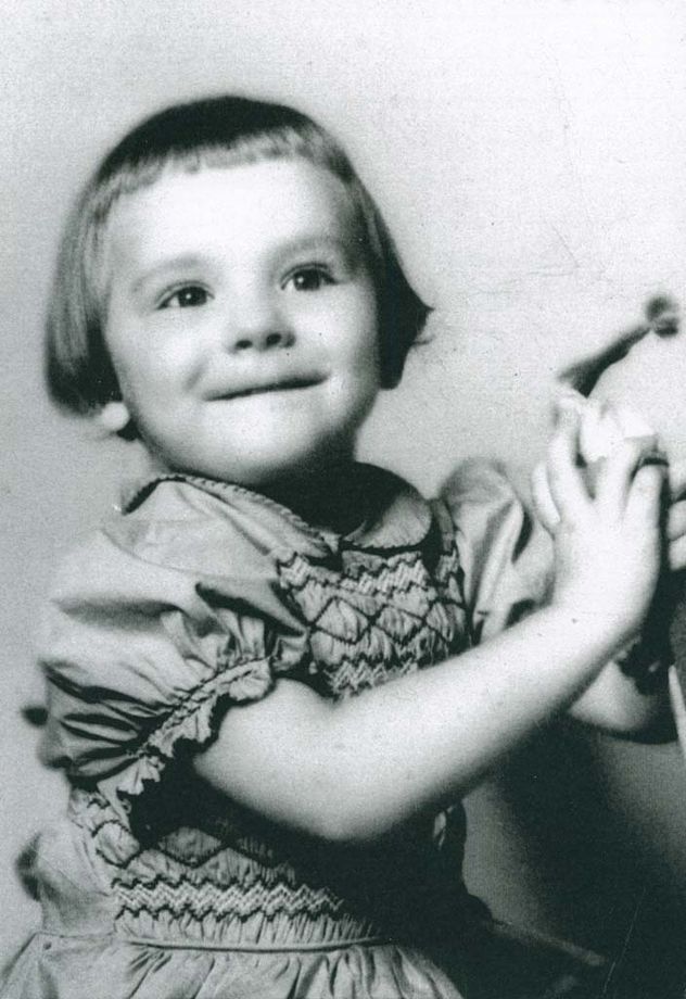 Rachael as a small child holding a tambourine